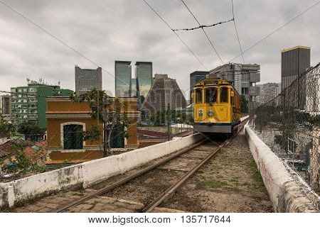 Rio de Janeiro, Brazil - June 18, 2016: The new version of iconic bonde tram is passing on the top of the Arch of Lapa, which was once an aqueduct.