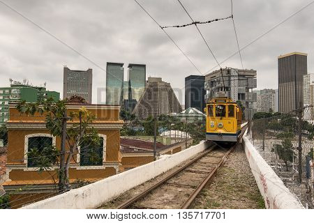 Rio de Janeiro, Brazil - June 18, 2016: The new version of iconic bonde tram is passing on the top of the Arch of Lapa, which was once an aqueduct.