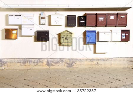 A bundge of postboxes / mailboxes / letterboxes photographed by night with bulb exposure.