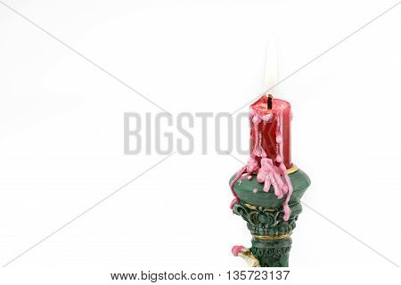 Bruning red aroma candle with wax on cupid holder isolated white background