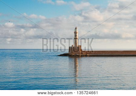 bay of Chania with watrs of Aegan sea and lighthouse at sunny summer morning, Crete, Greece