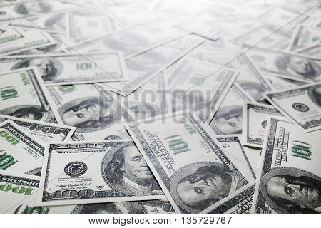 One hundred dollars pile. Money as background. Selective focus.