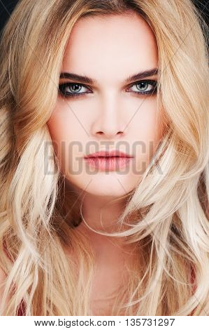 Gorgeous Fashion Model with Blonde Hair. Sexy Woman with Blonde Curly Hairstyle. Face closeup