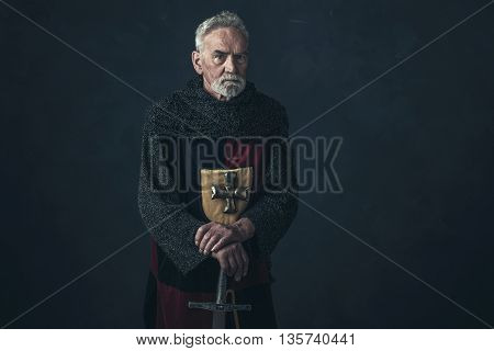 Senior Knight In Hauberk Standing With Sword.