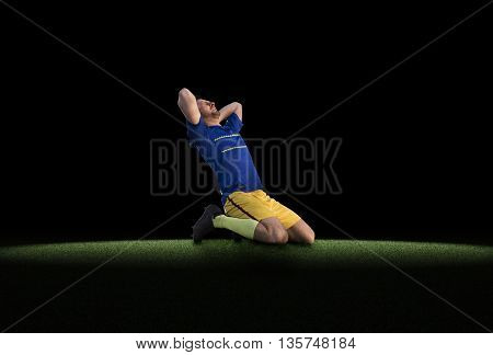 Frustrated soccer player in blue uniform isolated on football training on green grass