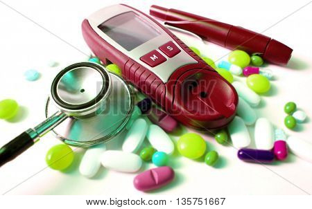 stethoscope,device for measuring blood sugar level and different kind of pills