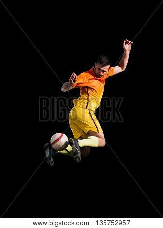 Activity soccer player in red kicking ball in jump on black background