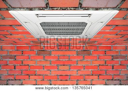 Built-in air conditioner for home and office embedded on the ceiling made of red brick.