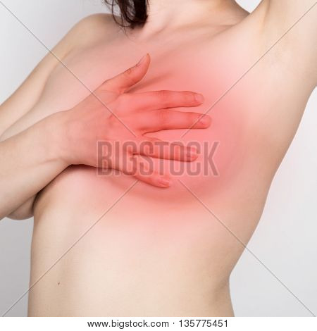 Breast cancer self check. Young woman examining her breast for lumps or signs of breast cancer. healthy lifestyle concept.