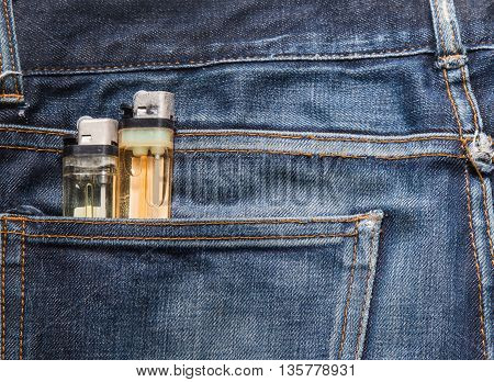 Jeans texture Blue denim jeans with cigarette lighter (focus on cigarette lighter)