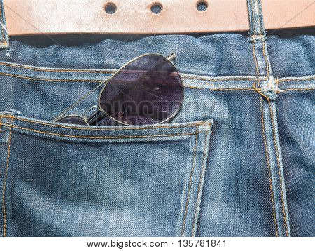 Jeans texture Blue denim jeans with lether belt and sunglasses