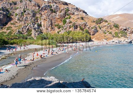 CRETEGREECE-JULY 23:Tourists on the Preveli Beach on July 232014 on Crete Greece. The beach of Preveli is situated 40 km south of the main town and is the most idyllic beach in Crete.