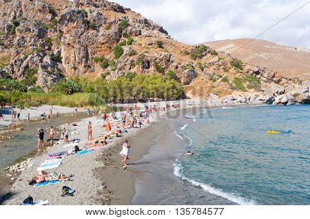 CRETEGREECE-JULY 23: Holidaymakers on the Preveli Beach on July 232014 on Crete Greece. The beach of Preveli is situated 40 km south of the main town and is the most idyllic beach in Crete.