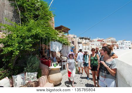 THERAOIA-JULY 28: Tourists on the Oia street on July 242018 in Oia town on the Thera(Santorini) island Greece.