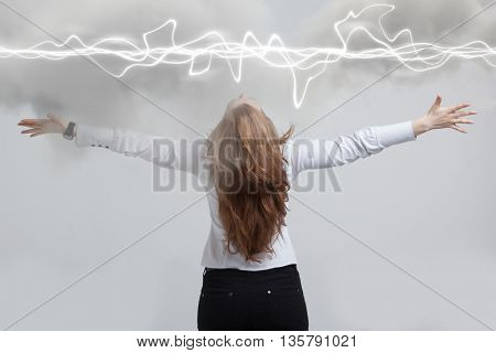 Woman making magic effect - flash lightning. The concept of electricity, high energy.