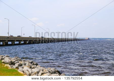 PENSACOLA BEACH, USA - MAY 13, 2015: View of the Pensacola Beach Bridge crossing the Santa Rosa Sound towards Gulf Breeze with plenty of cars driving on the bridge.