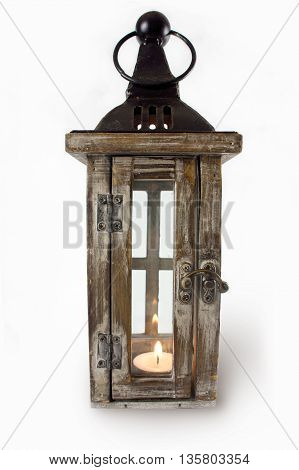 Christmas lantern with a burning candle on a white background.