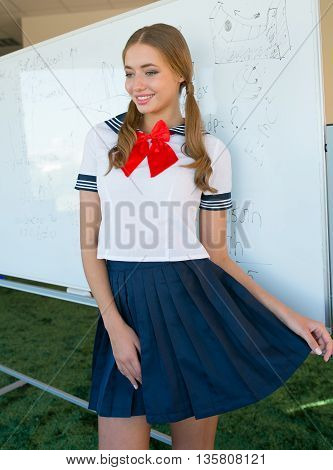 sexy naughty school girl in plaid skirt with attitude and showing side of breast