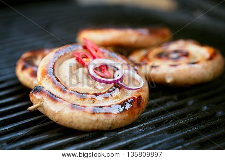 cumberland sausage, spiral pork sausage on bbq grill with no flame, homemade