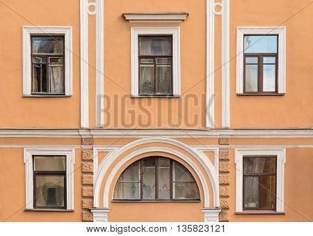 Several windows in a row on facade of urban apartment building front view St. Petersburg Russia