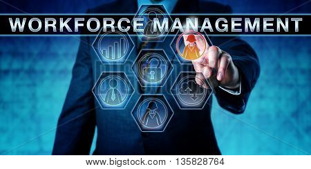 Businessman is pressing WORKFORCE MANAGEMENT on an interactive touch screen monitor. Human resource management metaphor and business software concept the development of a productive workforce.