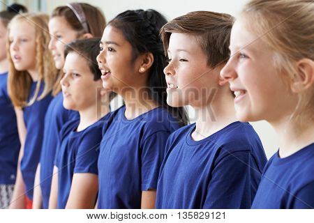 Group Of School Children Singing In Choir Together