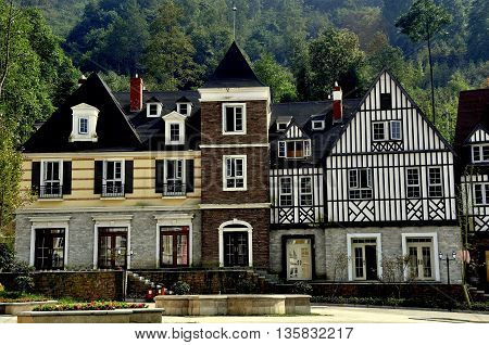 Bai Lu China - October 18 2012: Handsome French-inspired half-timbered and stucco houses line a village square *