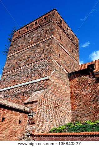 Torun Poland - May 26 2010: Outer wall facade of the 13th century square Leaning Tower (Krzywa Wieza) is a city landmark with its 1.40m inclination