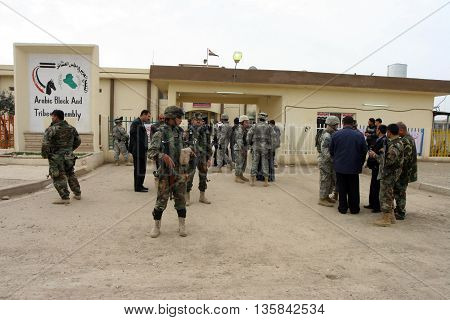 KIRKUK, IRAQ - FEBRUARY 2, 2007: Unidentified Iraqi soldiers and US soldiers stands guard on a check point on February 2, 2007 in Kirkuk, Iraq.