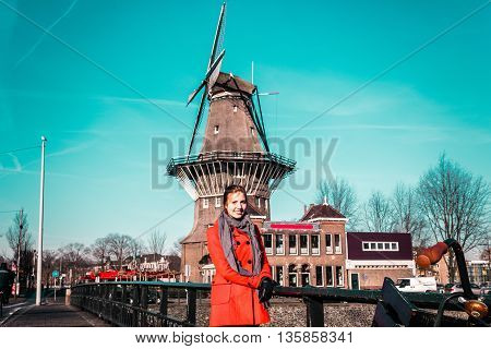 Girl In Front Of A Windmill In Amsterdam, Netherlands