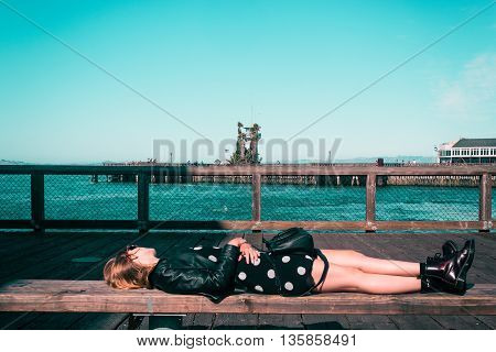 Girl Lying Down On A Bench At San Francisco, California