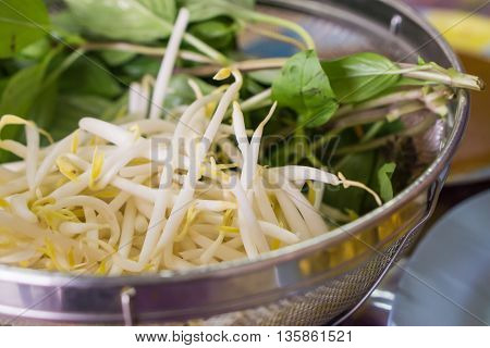closeup bean sprouts and basil eat with noodle soup Thai style