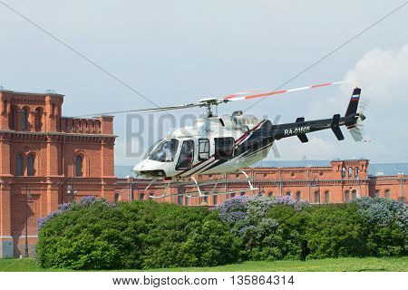 SAINT PETERSBURG, RUSSIA - MAY 22, 2016: The take-off of a private helicopter Bell 407GX (RA-01605) from the helicopter pad at the Peter and Paul fortress