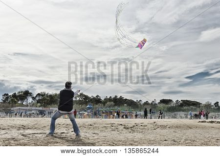 Cervia, Italy - April 30, 2016: Man manages kite during a kite festival
