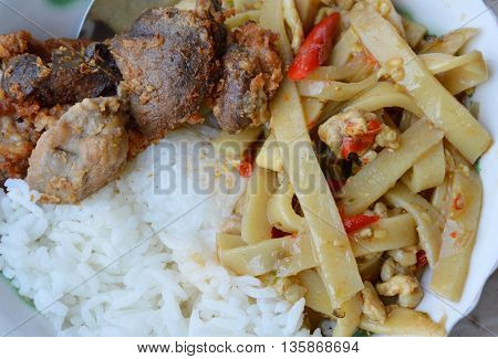 spicy bamboo shoot and deep fried chicken entrails on plain rice