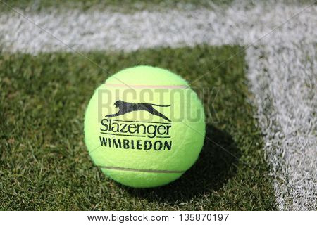 NEW YORK - JULY 21, 2015: Slazenger Wimbledon Tennis Ball on grass tennis court. Slazenger Wimbledon Tennis Ball exclusively used and endorsed by The Championships, Wimbledon