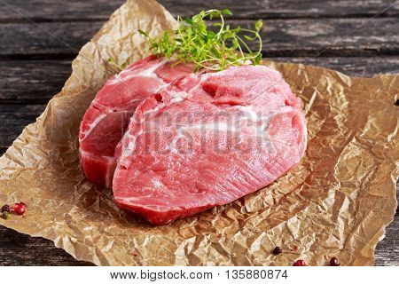 Fresh Raw Pork Shoulder on scrumbled paper.