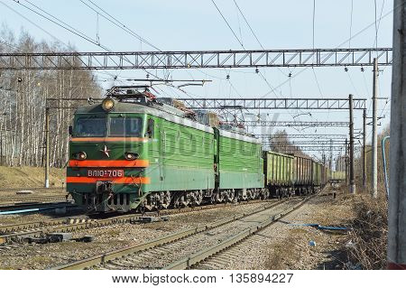 A cargo train pulls boxcars in the morning