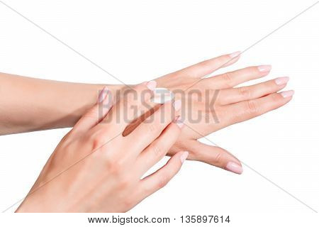 Female beautiful delicate manicured hands with moisturizing cream isolated on white background