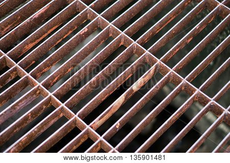rust steel sewer cover or sewage drain cover, on public road