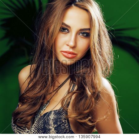 young cute blonde woman on green palm background smiling happy, lifestyle peole concept close up