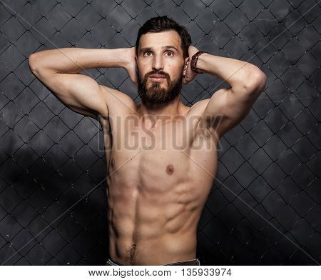 Shirtless muscular sexy guy with beard showing his great body