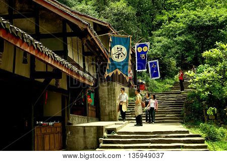 Dujiangyan China - April 24 2005: Visitors pause at a small cafe in a half-timbered hillside house reached by a long flight of stairs in Dujiangyan Historic Park