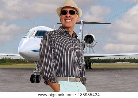 Fashionable man with a private jet in the background