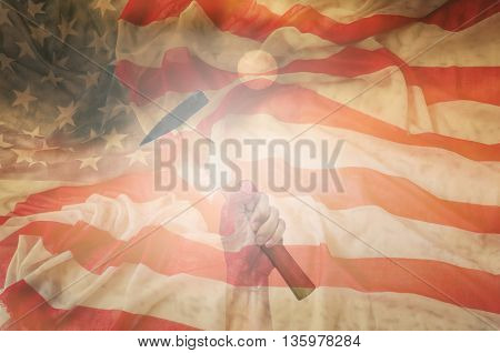 Hand holding hammer with usa flag backgrounddesign for labor day concept.