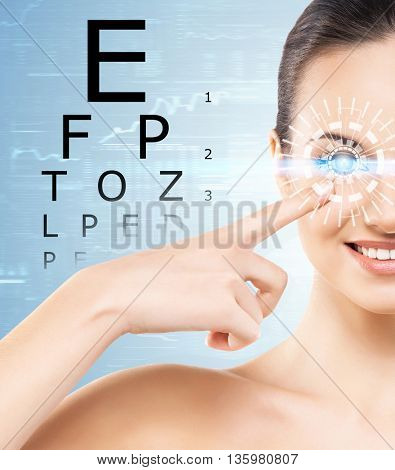 Beautiful woman with laser hologram and test vision table over cyan background.