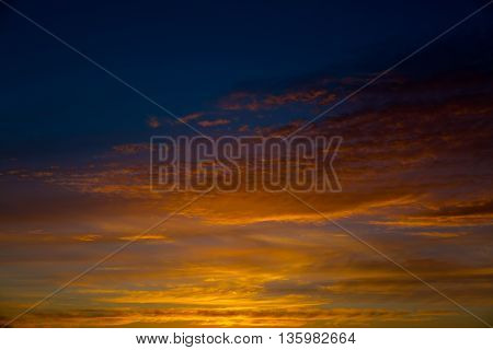 Fiery orange sunset sky. Beautiful sky. Bright orange and yellow colors sunset sky.