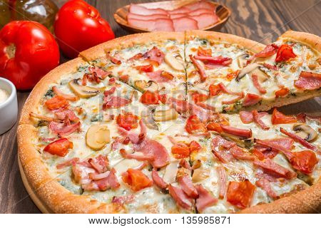 Delicious pizza with ingredients served on wooden table