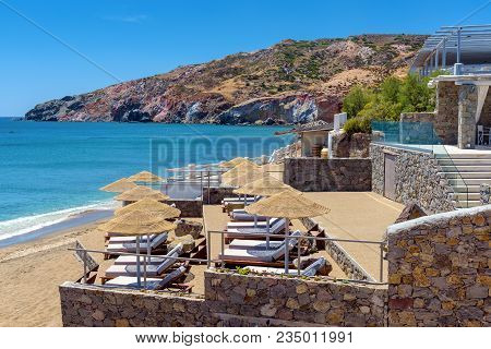 Sun Loungers With Umbrellas On Beautiful Sandy Paleochori Beach On Milos Island. Cyclades, Greece.
