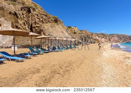 Milos, Greece - May 19, 2017: Sunbeds With Umbrellas On Beautiful Sandy Paleochori Beach On Milos Is